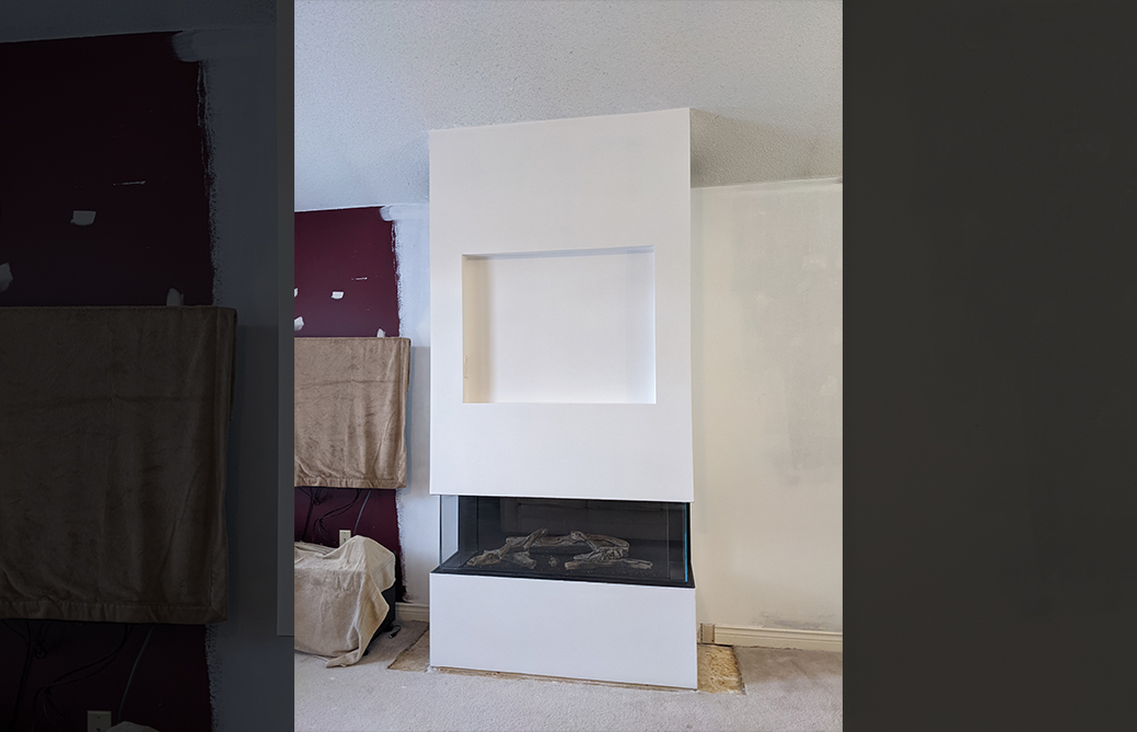 Three-sided contemporary gas fireplace installation in progress in Barrie